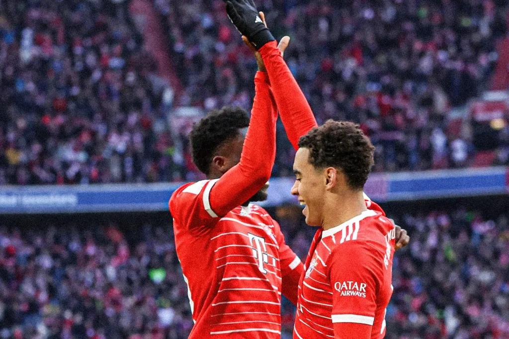 Jamal Musiala and Alphonso Davies celebrating